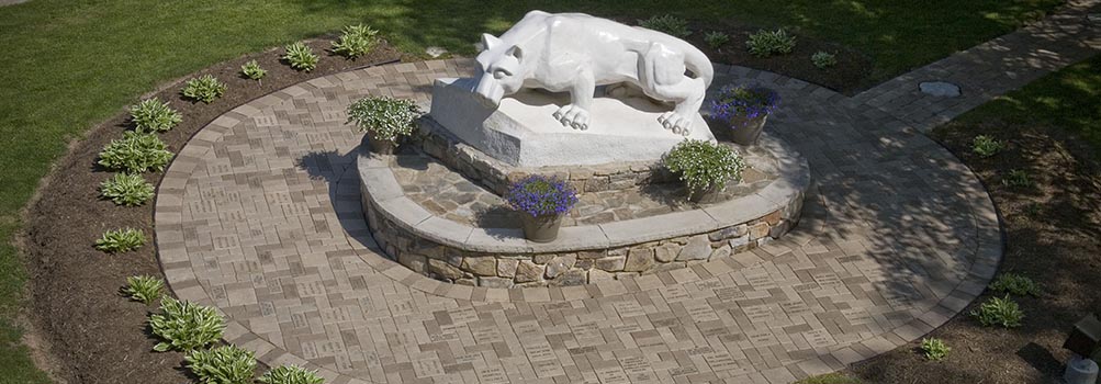 Nittany Lion statue with brick pathway
