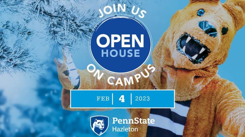 Nittany Lion with arms outstretched next to snow-covered tree.