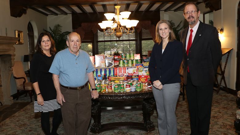 From left: Jaculin Scarcella, alumni and development stewardship officer; Rocco Formica, alumni chapter president; Christen Reese, director of development; and Gary Lawler, chancellor. The chapter oversees the food drive each year at the campus.