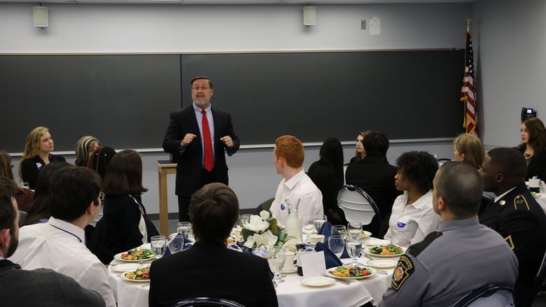 Michael True, a career services professional, leads last year's etiquette dinner at Penn State Hazleton.