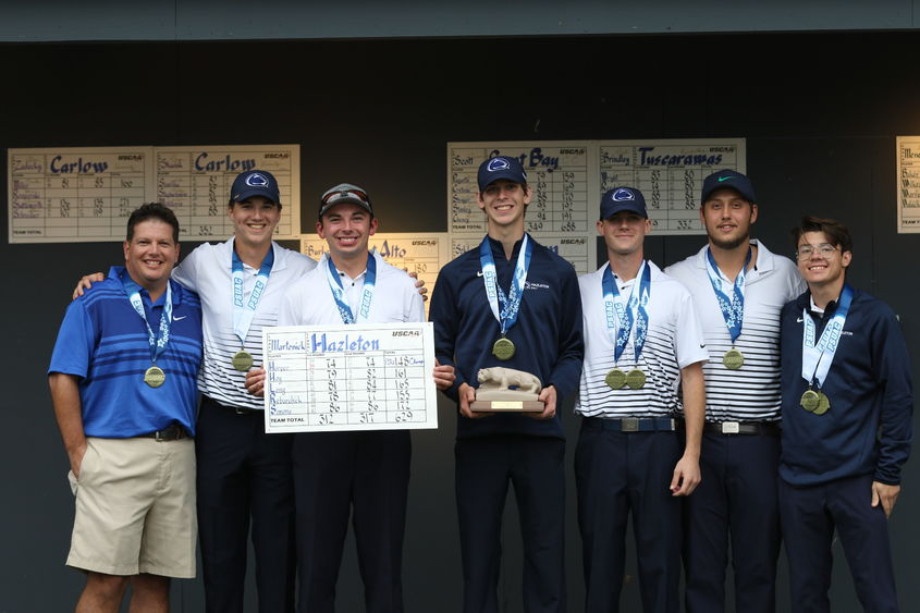 Group of golfers standing in a row wearing medals.