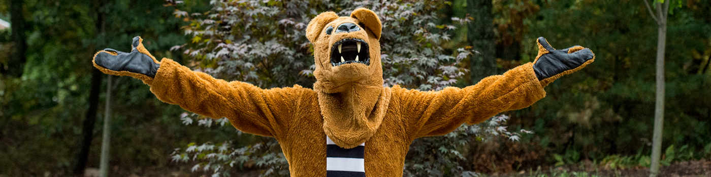 Nittany Lion mascot with arms outstretched to the side.