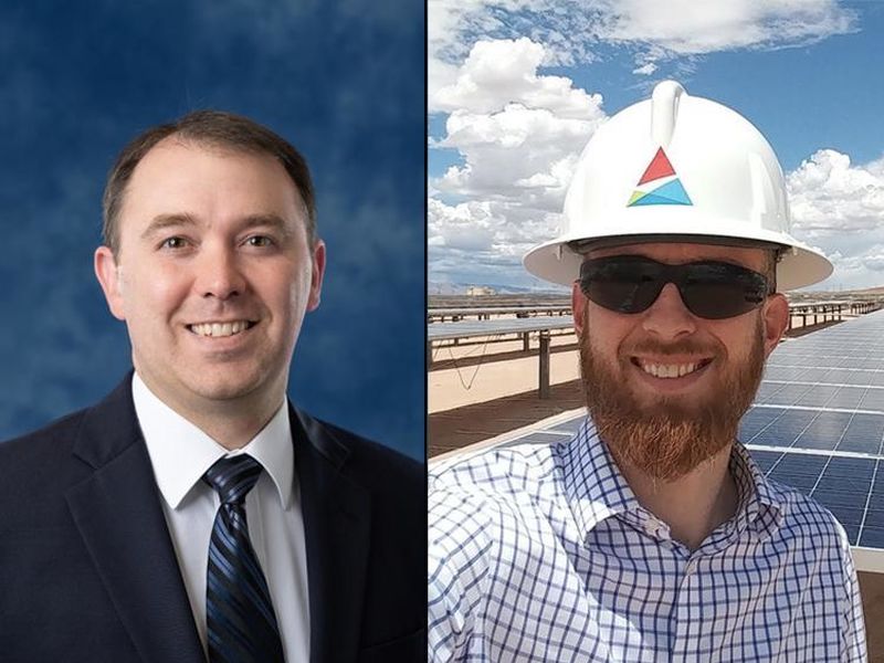 A smiling man in a suit and a smiling man in a hard hat and sunglasses. 