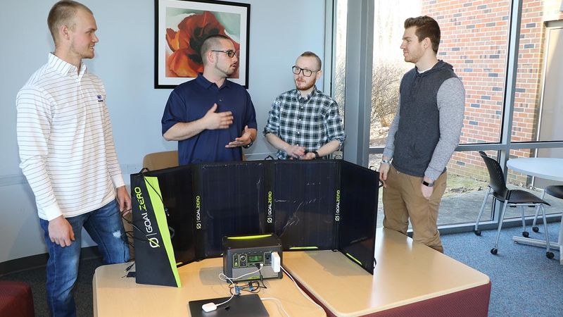Charlie Karchner, Jordan Williams, Dave Ecklund and Austin Yaletchko discuss their backup power accessibility project.