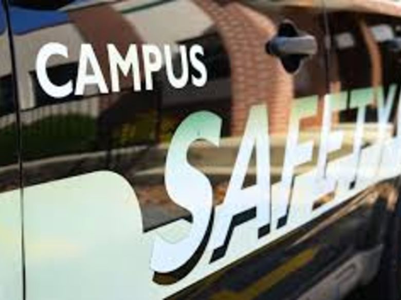 Side of campus safety vehicle with a reflection of a building. 