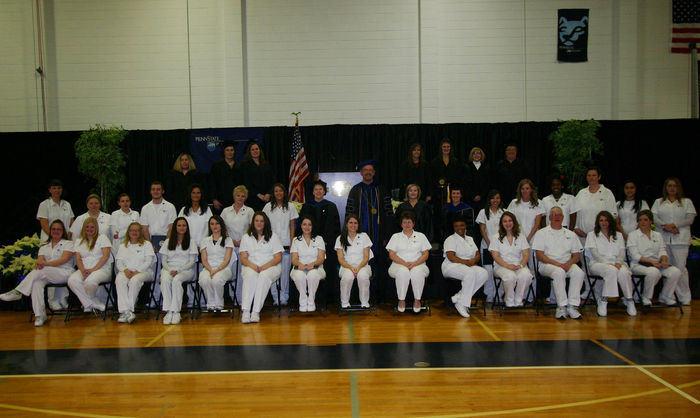 Practical Nursing Class of 2012 posing in gymnasium in two rows.