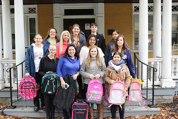 The students and Lorine Ogurkis meet outside Brandon's Forever Home with the donated bags.
