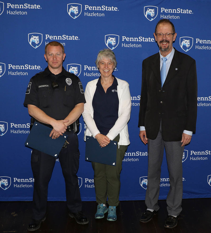 Among the employees honored for five years of service were Dale Osenbach, public safety officer, left, and Karen Stylianides, instructor in kinesiology, center. Chancellor Gary Lawler is at right.