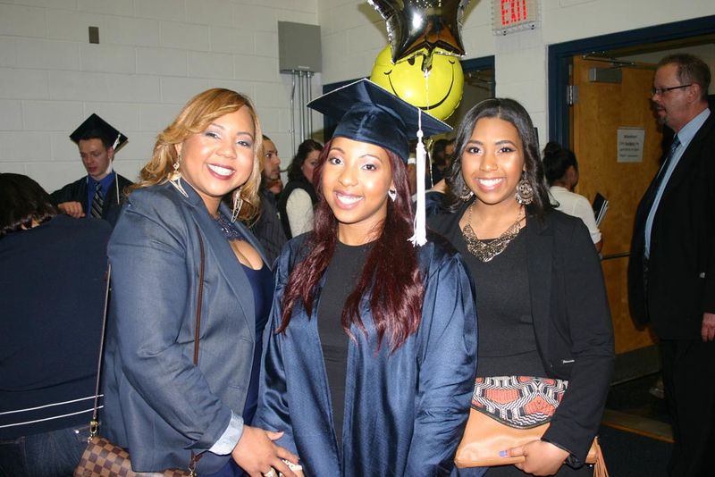 A new graduate celebrates with her family. 