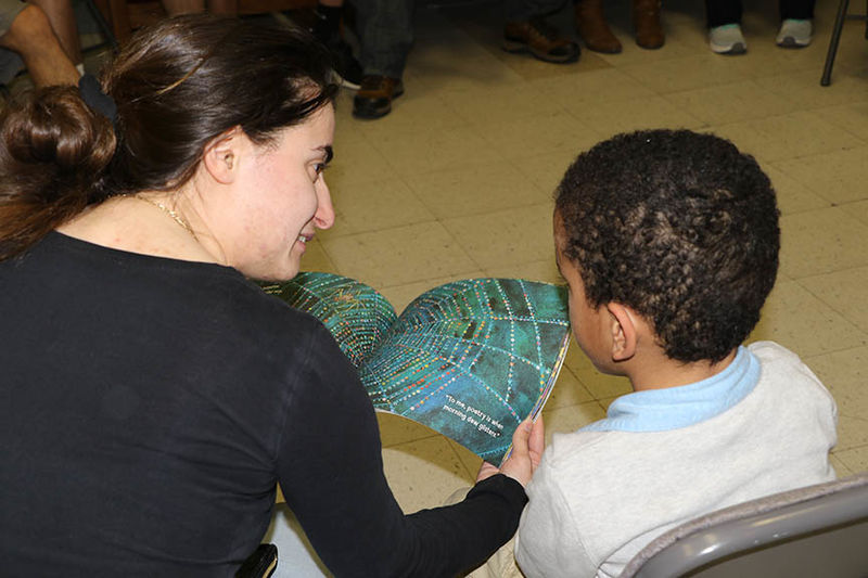 Veronica DiBlasi reads to a child in the Northeast Pennsylvania Migrant Education Program.