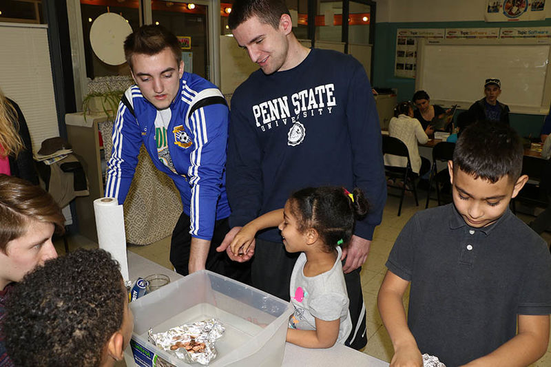 Penn State Hazleton students work with the children on activities based on "Daniel Finds a Poem."
