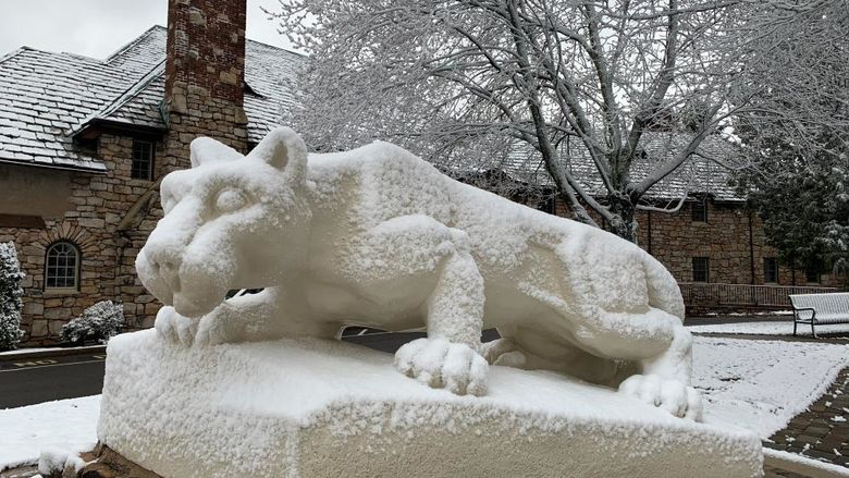 Statue of Nittany Lion covered in snow.