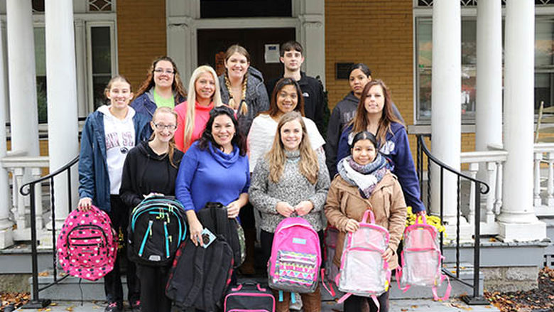 The students and Lorine Ogurkis meet outside Brandon's Forever Home with the donated bags.