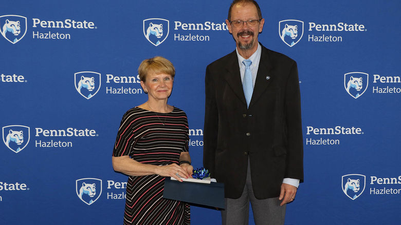 Debra Conway, director of continuing education, was honored for 20 years of service. Chancellor Gary Lawler is at right.