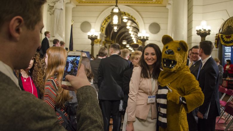 Lion mascot poses with woman