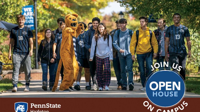 Students walking in a row along campus mall with Nittany Lion.