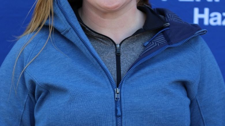 Penn State Hazleton Athletic Trainer Megan Bobish wearing blue windbreaker in front of Penn State Hazleton backdrop