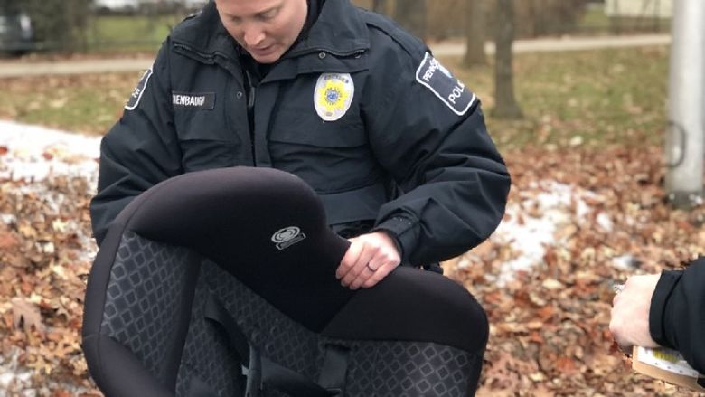 officer inspects child safety seat