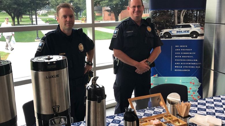 Officers setting up for coffee with a cop event.