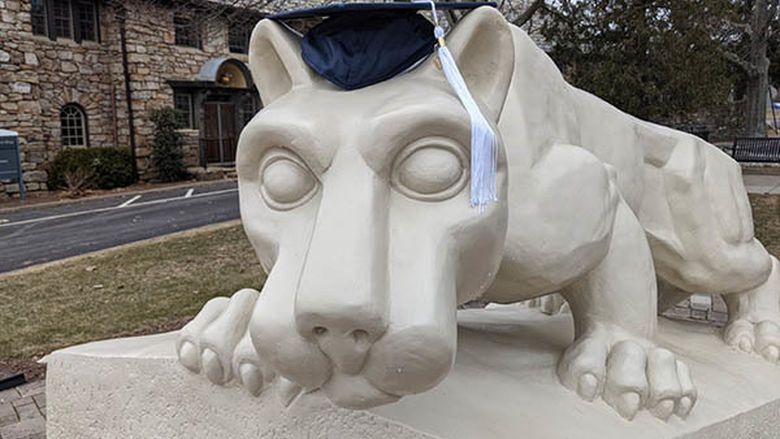Nittany Lion statue with mortar board
