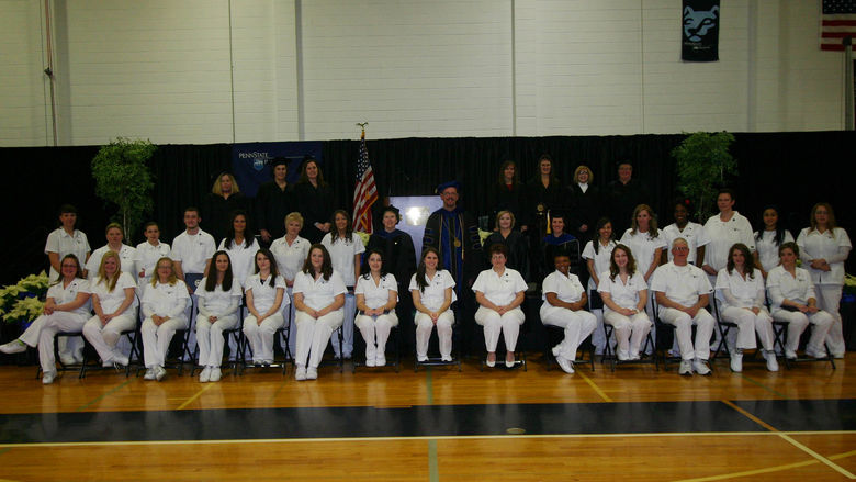 Practical Nursing Class of 2012 posing in gymnasium in two rows.