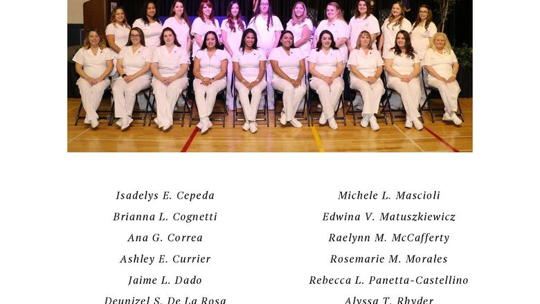 Group of nurses in white scrubs seated in two rows