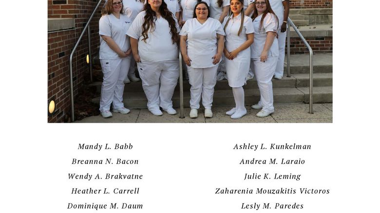 Group of nurses in white scrubs standing in two rows