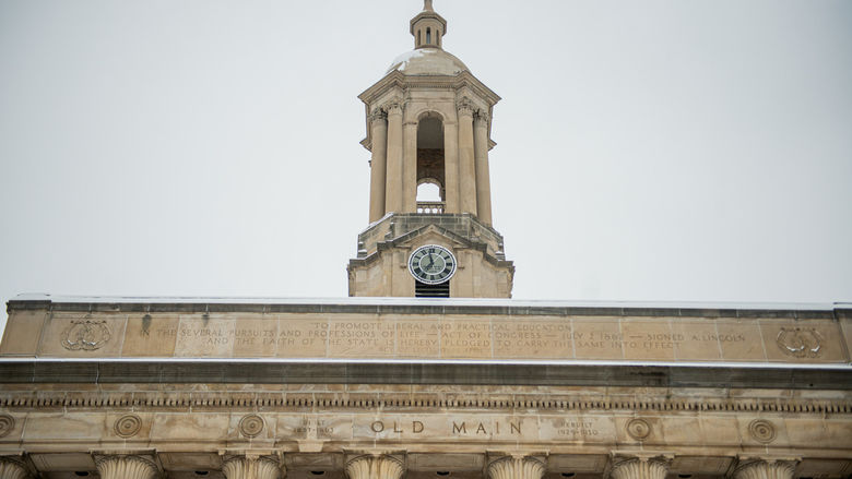 Tower of campus building with grey skies in background.