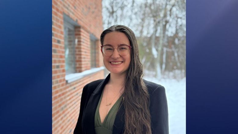 A portrait of Saraiha Rossi standing outside with a snow-covered background