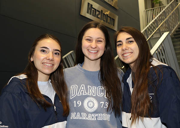 Three smiling females with dark hair. 