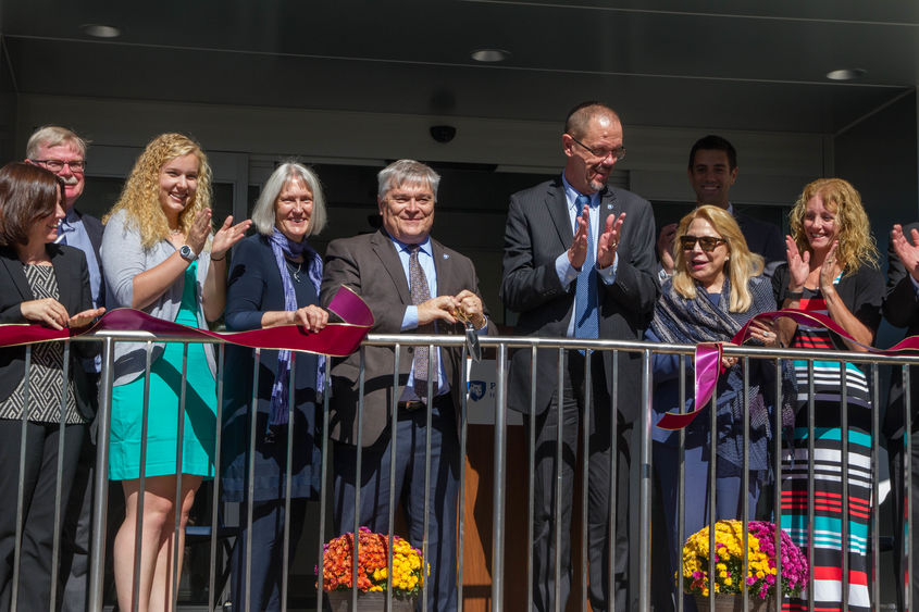 The group celebrates the rededication of the Kostos Building.