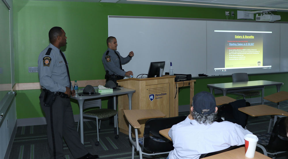 Trooper Marvin Armistead, left, and Trooper David Myers address Daniel Gutierrez’ “Policing in America” class at Penn State Hazleton.