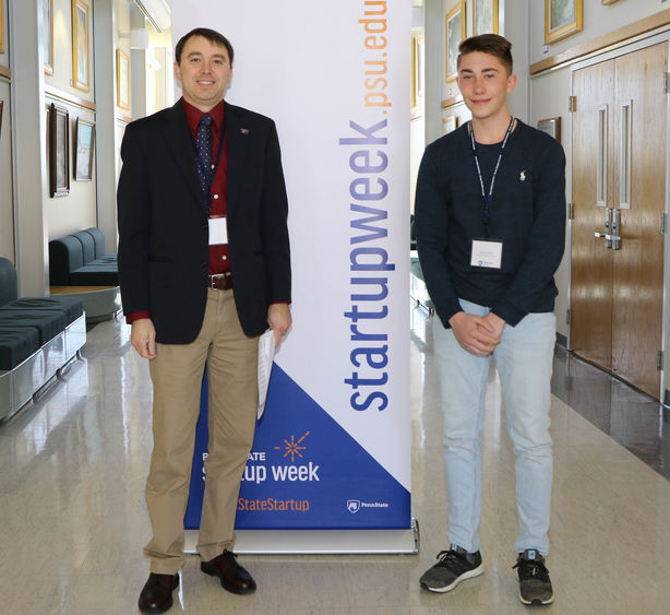 Penn State Hazleton Associate Professor of Engineering and chair of the STEM Research Fair Joseph Ranalli, left, congratulates Kyler Hower for capturing first place in the competition. 