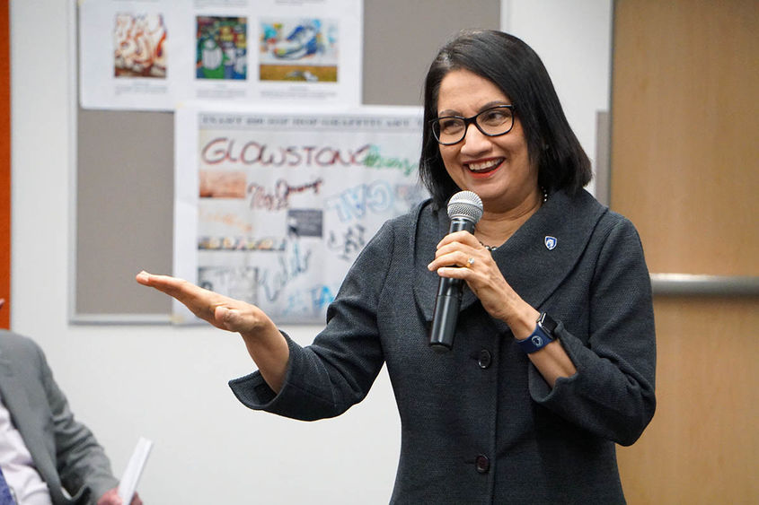 President-elect Neeli Bendapudi speaks into a microphone inside a classroom