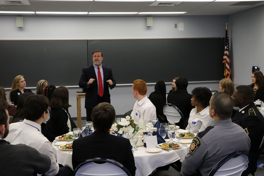 Michael True, a career services professional, leads last year's etiquette dinner at Penn State Hazleton.