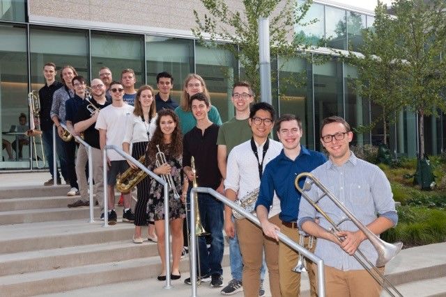 members of the Centre Dimensions jazz ensemble pose for a photo outside of a building