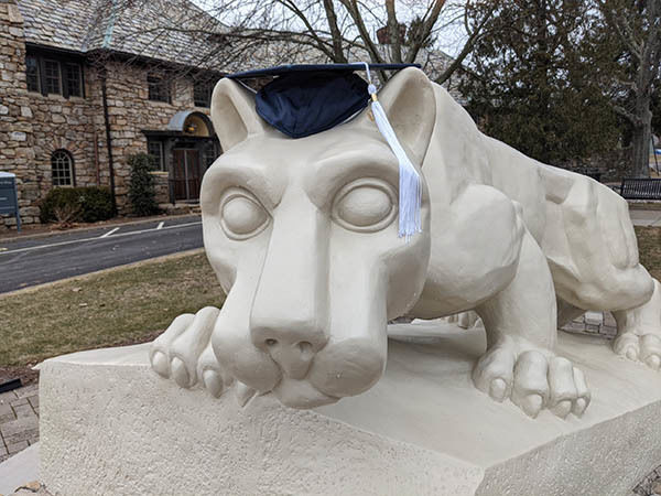 Nittany Lion statue with mortar board