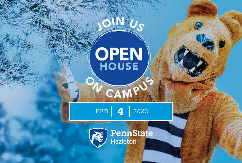 Nittany Lion with arms outstretched next to snow-covered tree.