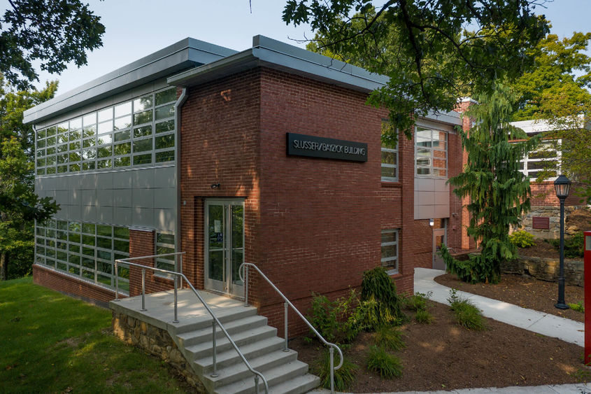 Brick building with trees surrounding it.