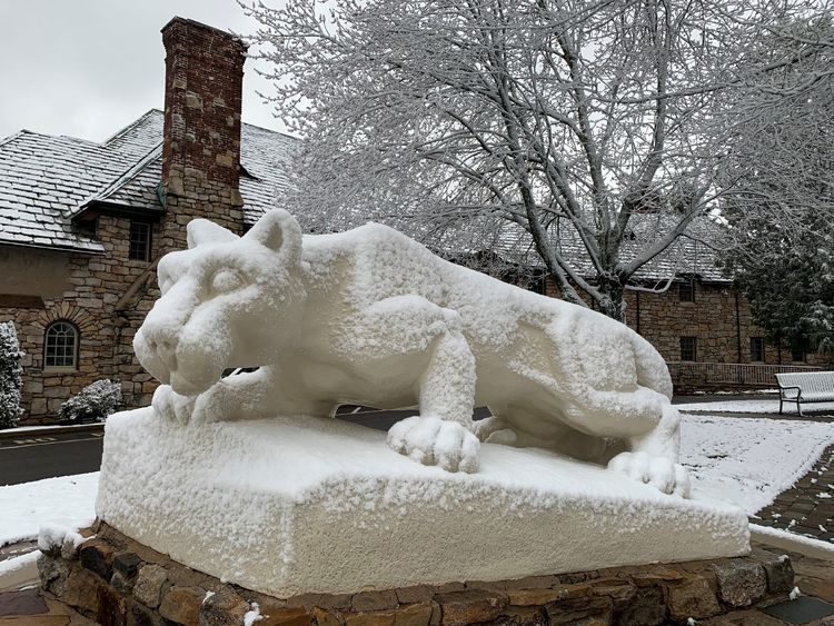 Statue of Nittany Lion covered in snow.